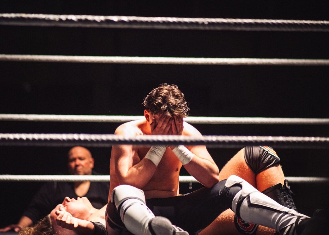 Wrestlers grappling inside the ring (Pexels 29714442)