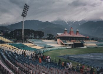Covers on a cricket ground under heavy cloud, as rain wiped out the Asian Games cricket quarter-finals