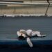 White boxing gloves resting on the canvas of an empty ring (Pexels 9944239)