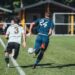 Two footballers chasing the ball during a match (Pexels 6800039)