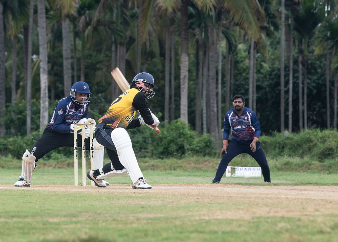 Cricket batsman playing a shot with wicketkeeper behind (Pexels 30671896)