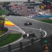 Formula 1 cars racing through a corner at Spa-Francorchamps in front of a packed crowd (Pexels 39520687)