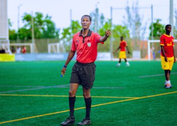Football referee pointing during a grassroots match, illustrating the FA Cup replay referee error