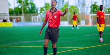 Football referee pointing during a grassroots match, illustrating the FA Cup replay referee error