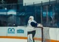 Ice hockey goaltender leaning on the net (Pexels 38553661)