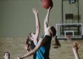 Lynx vs Fever: women basketball players contest a jump ball on an indoor court