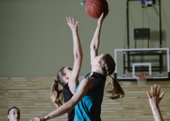 Lynx vs Fever: women basketball players contest a jump ball on an indoor court