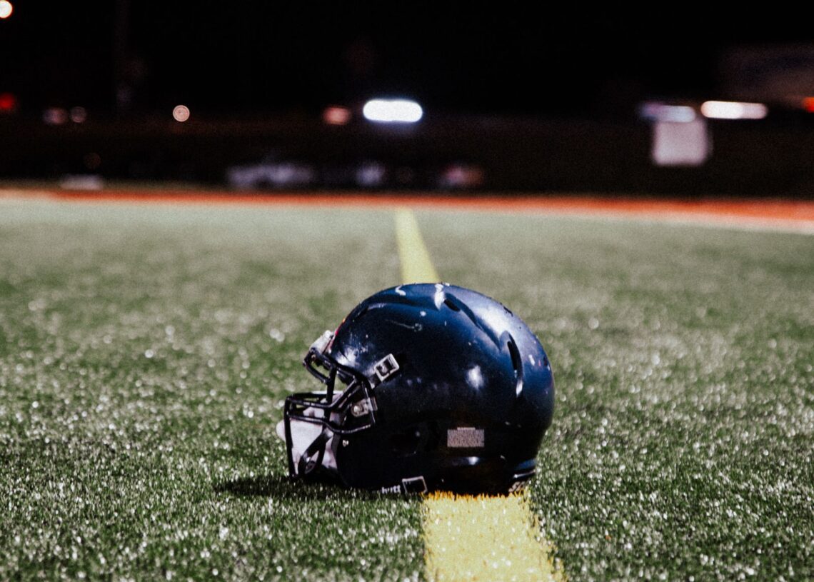 American football helmet on the field at night, Ole Miss vs Florida college football