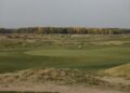 Golf green with a flag in autumn, illustrating Presidents Cup scores from Medinah
