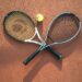 Two tennis rackets and a ball on a clay court (Pexels 27152933)