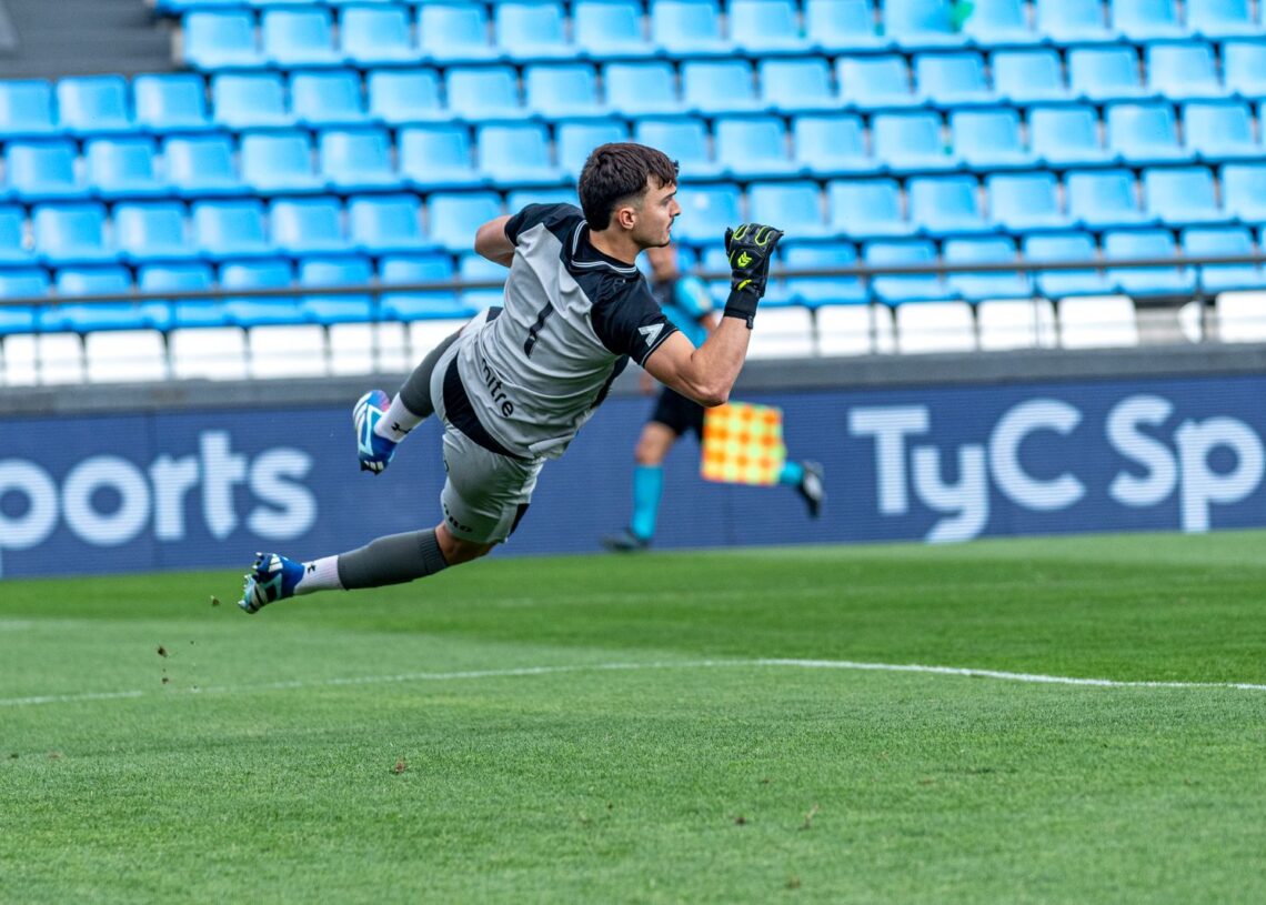 Slovenia vs Scotland: a goalkeeper dives to make a save in a Nations League-style match