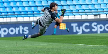 Slovenia vs Scotland: a goalkeeper dives to make a save in a Nations League-style match