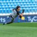 Slovenia vs Scotland: a goalkeeper dives to make a save in a Nations League-style match