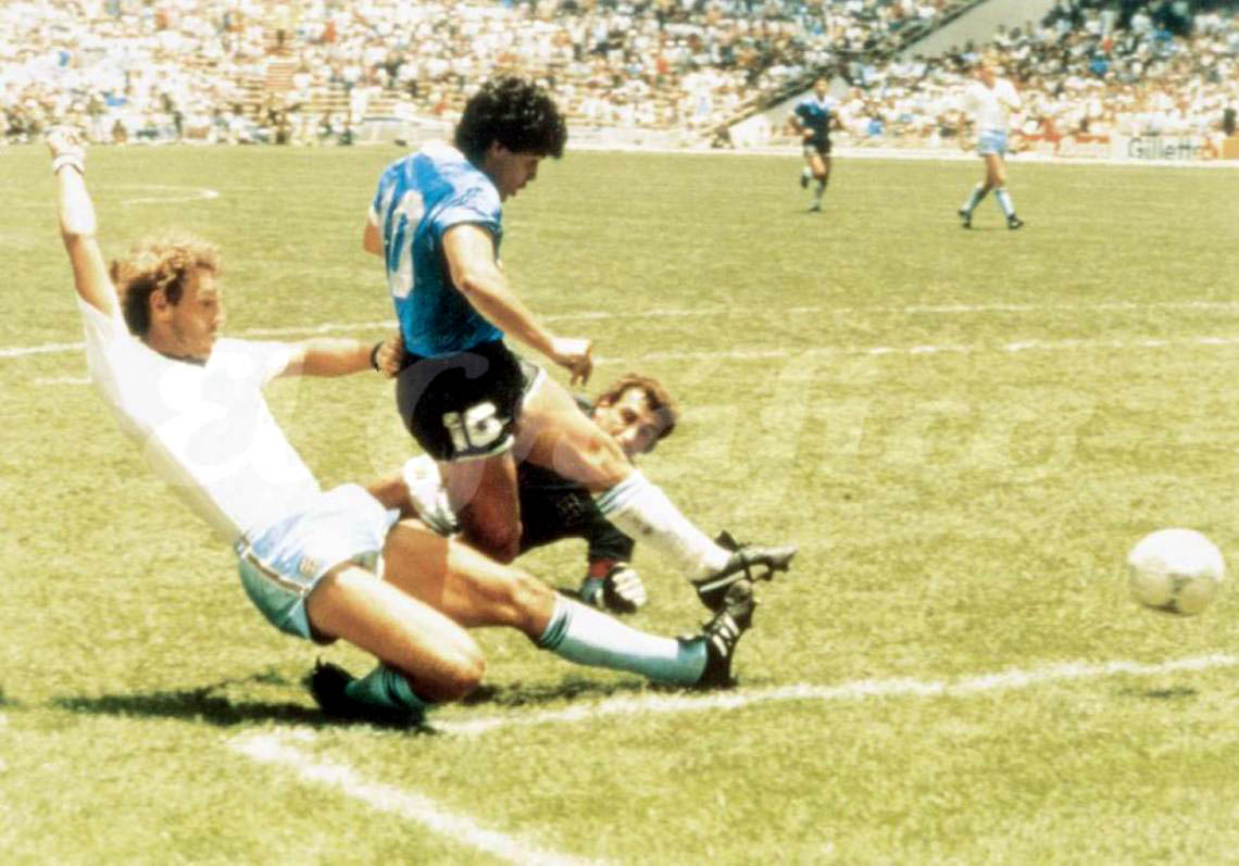 Diego Maradona scoring for Argentina in the blue away shirt against England at the 1986 World Cup