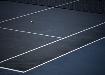 Tennis ball on a blue hard court