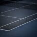 Tennis ball on a blue hard court